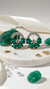  Diaura gold plated emerald green heart cluster hoop earrings on white marble with emerald stones crystals gold flakes, model in white top