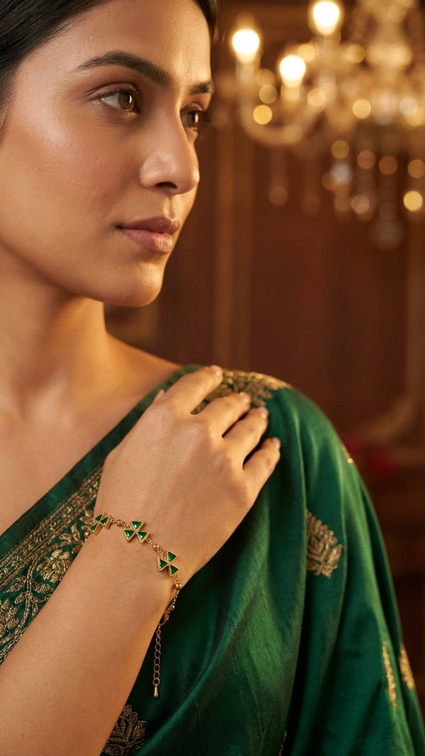 Diaura Jewels minimalist 18K gold plated bracelet featuring four-leaf clover motifs with emerald green trillion-cut zircons